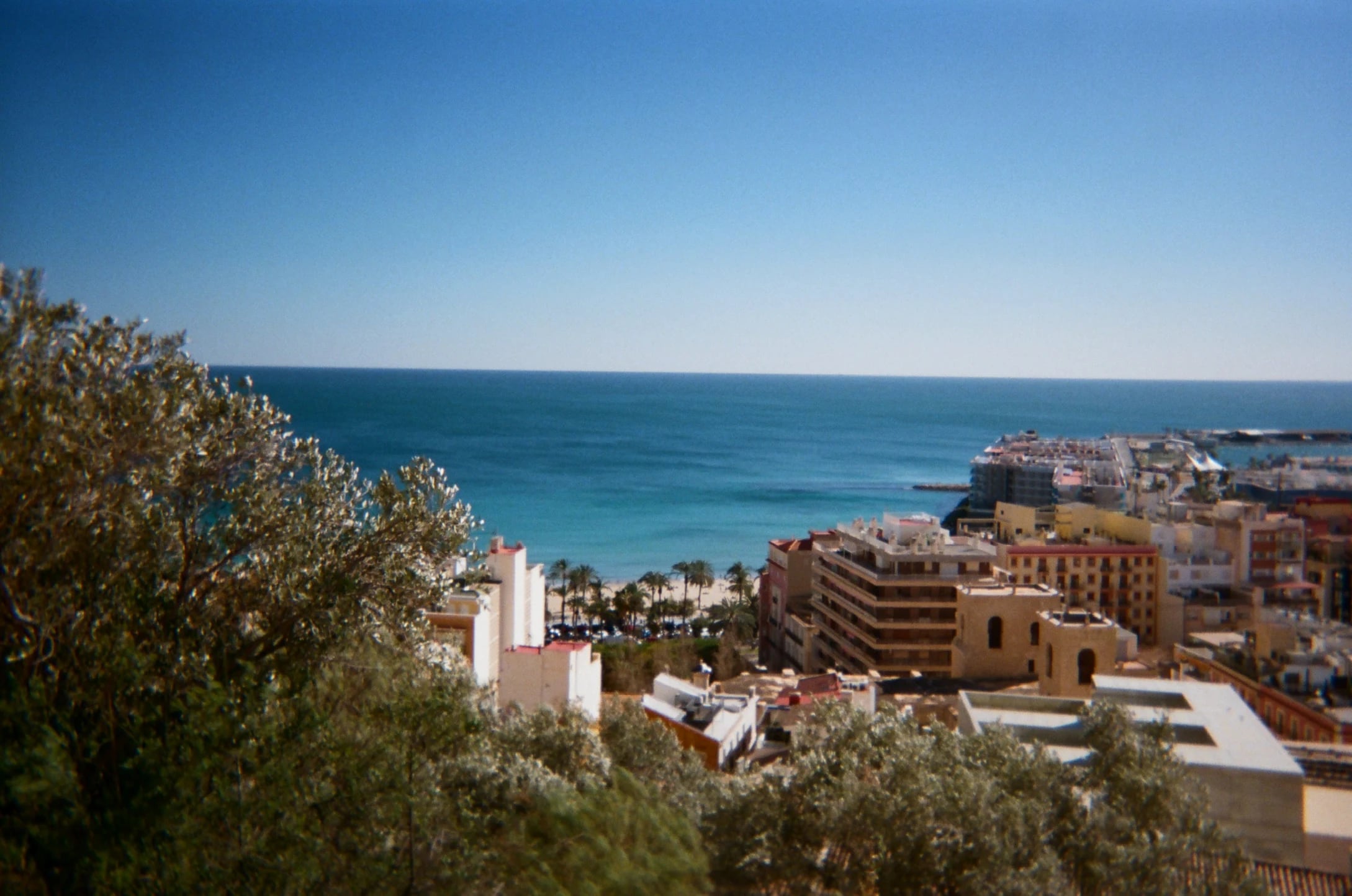 Coastal city and blue sea viewed from above