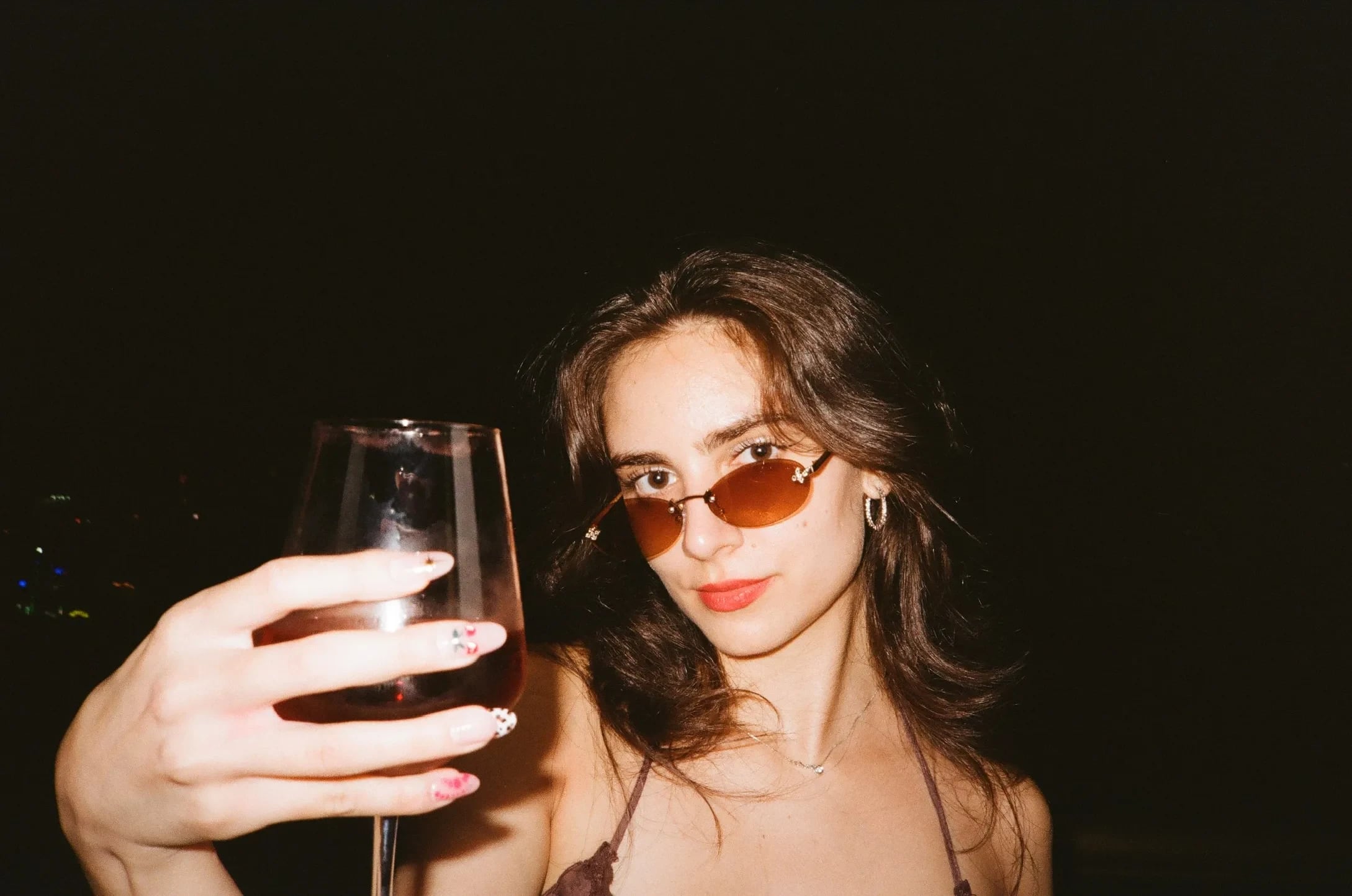 Night portrait with a raised glass