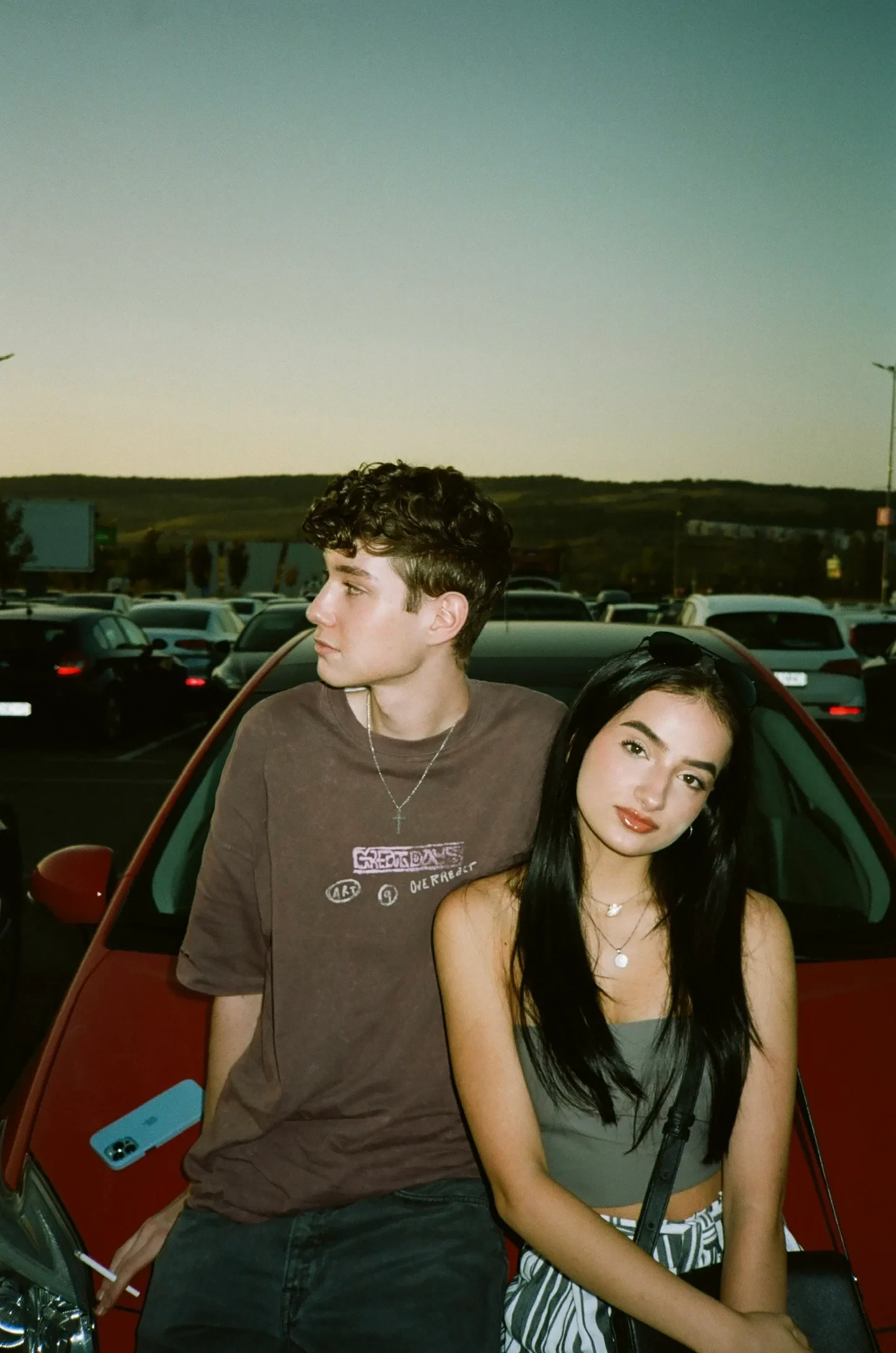 Portrait of two people beside a car — final edit